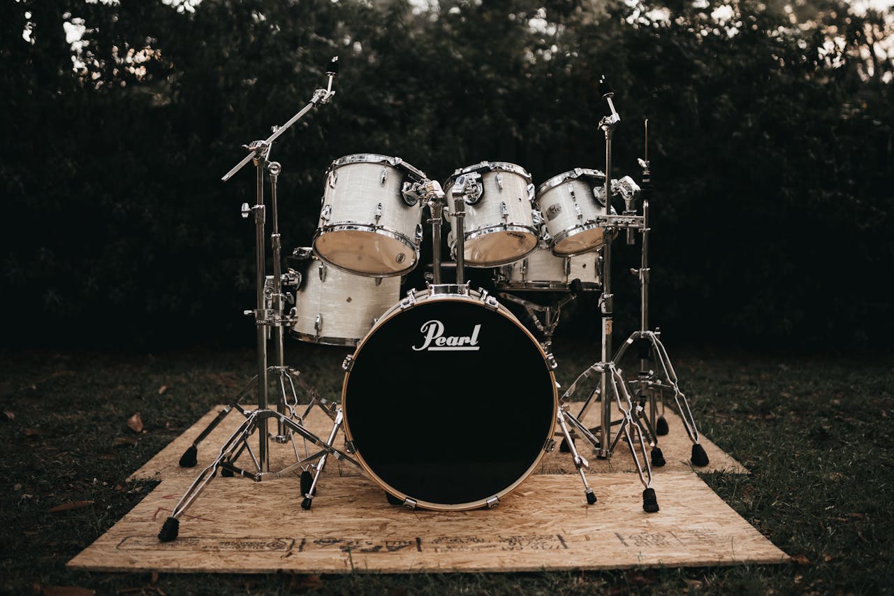 The Art of Drawing Readers In: Your attractive post title goes here A classic Pearl drum set displayed outdoors, perfect for music enthusiasts.