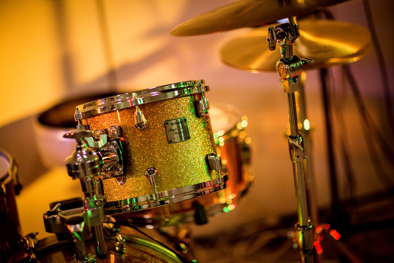 Mastering the First Impression: Your intriguing post title goes here A vibrant close-up photo of a glittery drum set under concert lights, evoking a lively music performance.